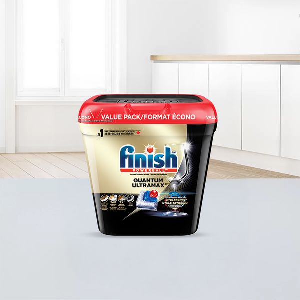 A package of Finish dishwasher tablets on the countertop of a modern kitchen.