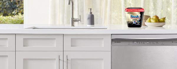 Modern kitchen with Bosch dishwasher and Finish Quantum detergent on the countertop