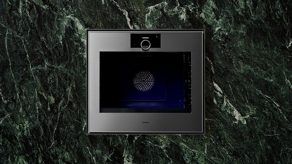 Expressive series oven with green marble wall behind.