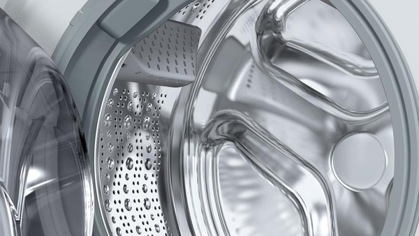 A front-loading washing machine with its door open, revealing the empty drum.