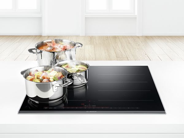 pots of food sitting on an induction cooktop
