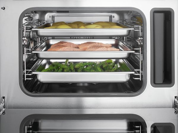 Bosch steam appliance cooking several different foods