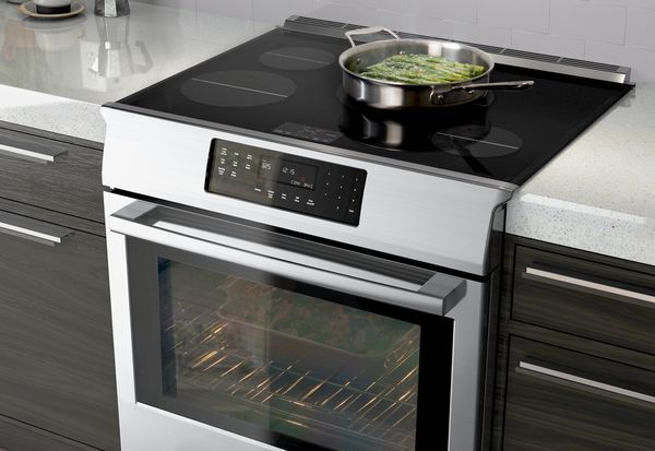 Bosch induction range with food on cooktop. 
