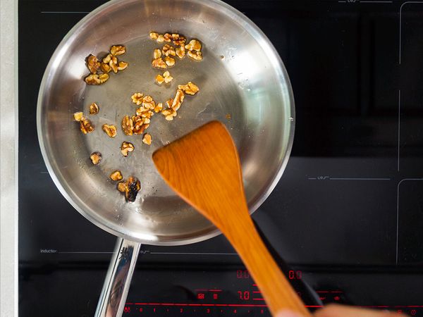 Frying the walnuts till they turn light brown