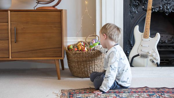 Child picking toy from basket