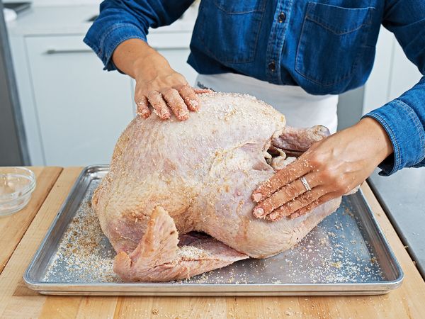 Turkey being brined on baking sheet