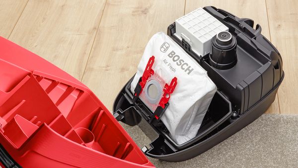 Inside of a bagged Bosch vacuum cleaner showing the dust bag and filter