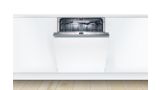 Fully-integrated Bosch dishwasher in a modern white kitchen with controls on top of door