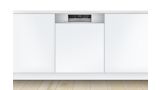Semi integrated Bosch dishwasher with a stainless steel control panel, in a modern white kitchen 