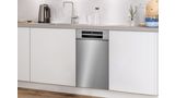 Undercounter slimline dishwasher in a stainless steel finish in a white kitchen.
