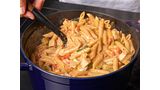 Mixing pasta in a pan