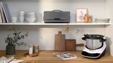 Grey tool bag stored on a shelf above the Cookit, which stands on the worktop.