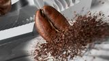 Close-up of coffee bean being ground.