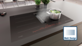 Bosch Induktionskochfeld mit integriertem Dunstabzug in Schwarz Matt auf moderner Arbeitsplatte.