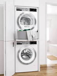 Stacked Bosch dryer and washer with a convenient pull-out shelf for laundry.