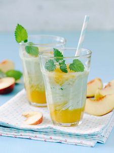 A refreshing apricot-peach yoghurt drink – with a hint of mint standing on a table.