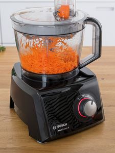 Carrot being chopped and shredded in food processor