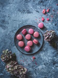 Red raspberry macaroons on a plate. 