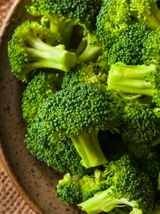 Fresh broccoli florets in a bowl.