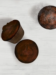 Three muffins on a counter.