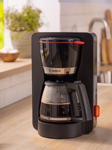 Black MyMoment coffee maker on kitchen top.