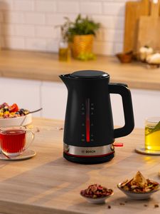 MyMoment kettle surrounded by hot drinks on kitchen top.
