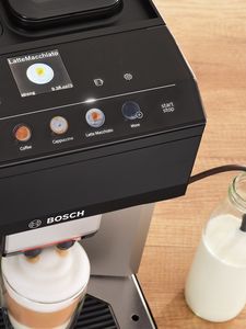 Bird's eye view of coffee machine with Easy Select Panel and cup of coffee under frother.