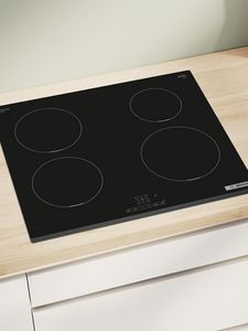 Induction hob on wooden countertop