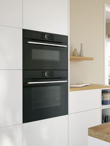 Bosch ovens built into white cabinets in light style kitchen