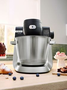 Kitchen machine sat on countertop with food around it