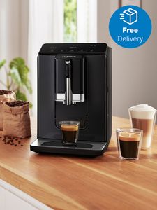 Hot mug of black coffee next to coffee machine on countertop with free delivery icon in top right corner