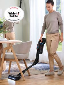Person using Bosch Vacuum Cleaner flex under table in living area, with Which Best Buy Jan 2025 Cordless Vacuums icon