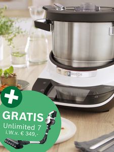 Cookit mit Edelstahlbeh&auml;lter auf wei&szlig;-schwarzer Basis, davor gr&uuml;ner Kreis mit Text und Bild eines Handstaubsaugers mit Text 'gratis Unlimited 7 i.W.v. 349&euro;'.