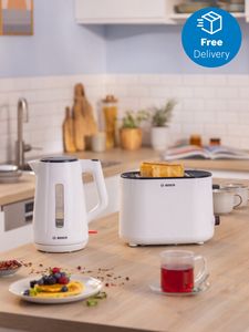 Kettle and toaster on kitchen countertop with food and drinks nearby