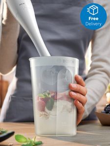 Person using hand blender with multiple ingredients