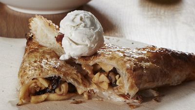 Apple turnover cut in half showing inside with ice cream on top