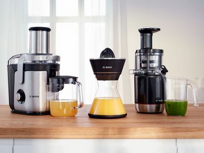 Line up of two Bosch juicers on a kitchen worktop.