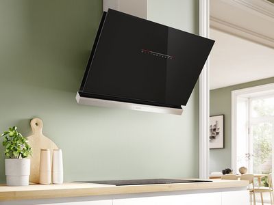 Angled cooker hood in green coloured space