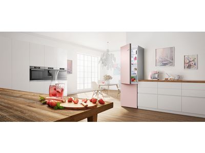 Stainless steel fridge freezer in a bright, modern kitchen.
