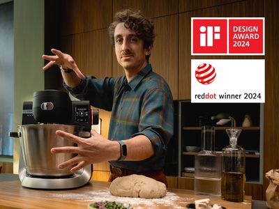 Un robot pâtissier Série 6 sur un plan de travail de cuisine et un homme faisant un mouvement magique de la main.
