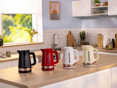 MyMoment kettles on a kitchen top in black, red, white and cream.