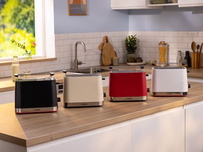 MyMoment toasters on a kitchen top in black, cream, red and white.