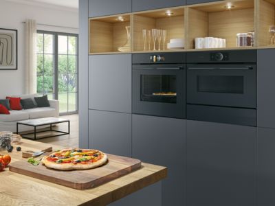 Built-in microwave in a white and wood kitchen