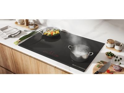 Bosch induction cooktop with speedboost pots and pans filled with veggies