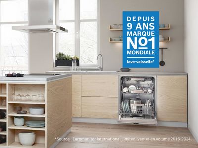 Lave-vaisselle Bosch encastrable ouvert dans une cuisine blanche moderne.