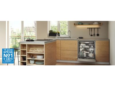 Біла кухня з дерев'яними елементами та з відчиненим заповненим приладом.