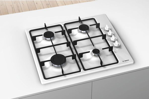 A white enamel Bosch Series 2 gas hob that's built in to a white countertop.