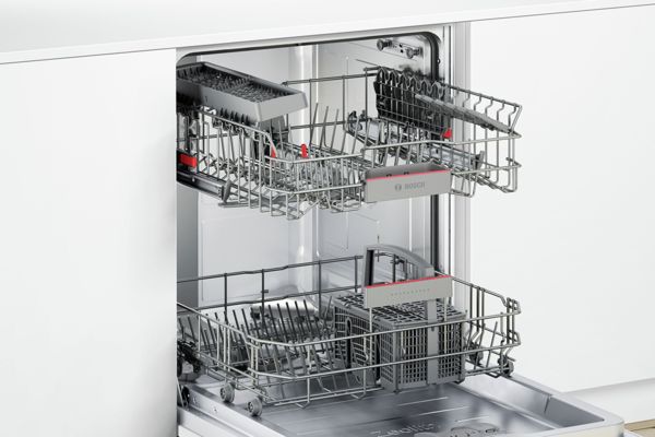 A look inside an empty Bosch dishwasher with two rack system and cutlery basket