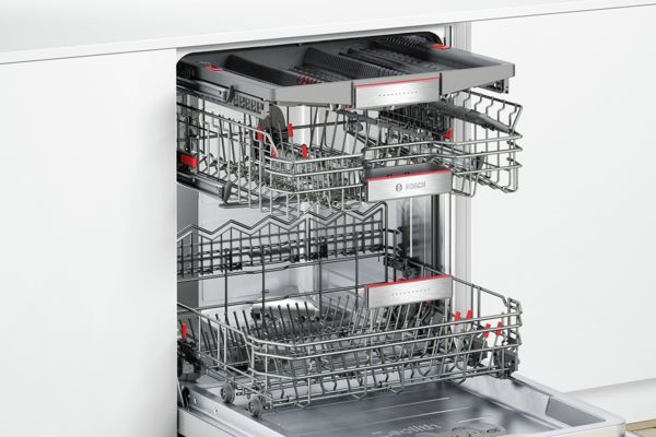 Uma máquina de lavar loiça Bosch aberta a mostrar o sistema de 3 cestos para pratos, tachos e talheres.