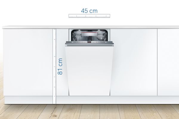 Built-in 45 cm wide slimline dishwasher in modern white kitchen with controls on door's top.